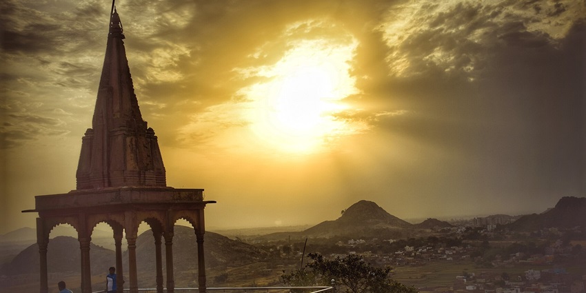 The top of Tagore Hill is visible from far away, with rocky hills and trees in complete view