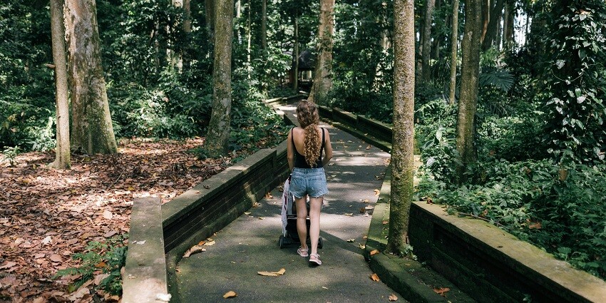 A scenic view of a woman strolling in a park, one of the best things to do in Lonavala.
