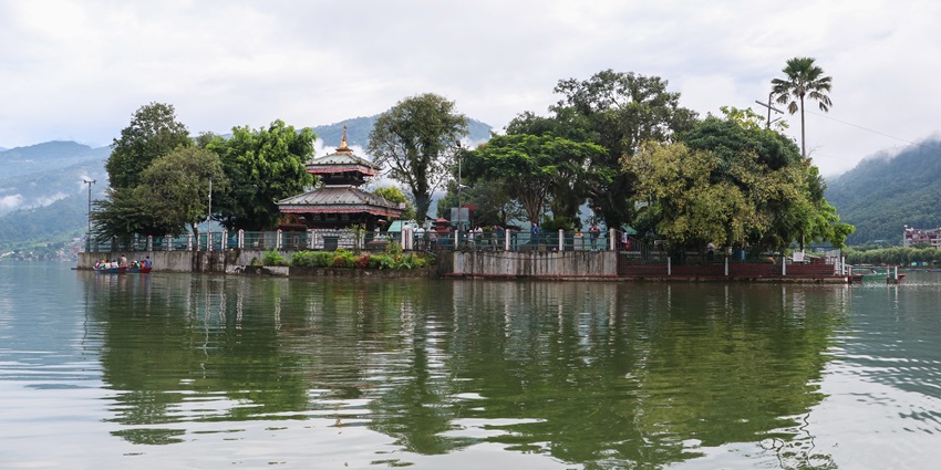 A glimpse of the iconic Tal Barahi Temple on an island surrounded by blue waters.