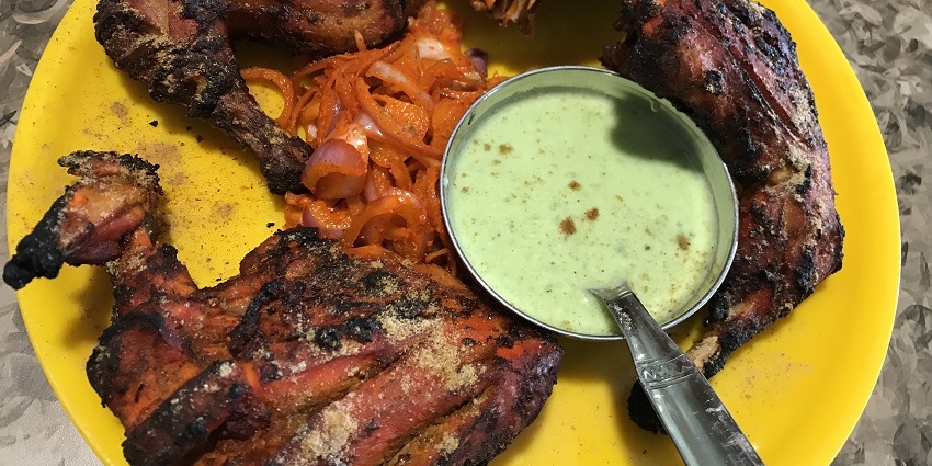 Snapshot of the grilled Tandoori Chicken and the chutney served in the plate in a restaurant in Ambala