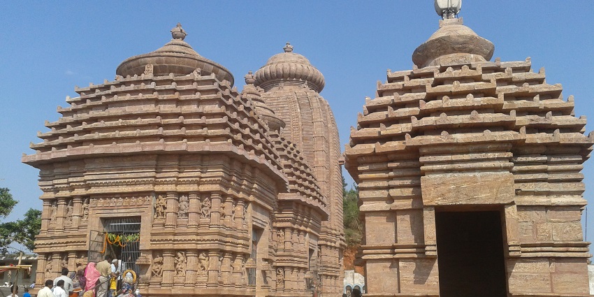 Devotees lined up to enter the ancient Taratarini Temple adorned with intricate carvings