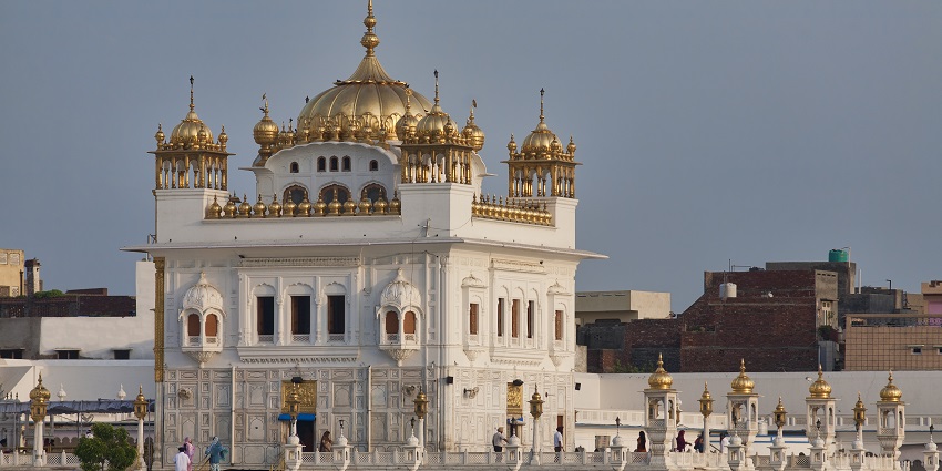 An image of the serene Tarn Taran Sahib Gurudwara, surrounded by tranquil waters.