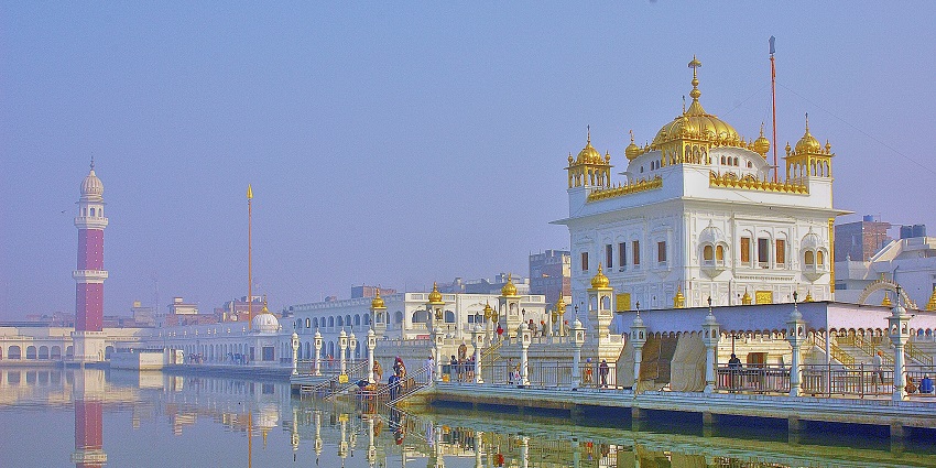 A breathtaking vista of Tarn Taran Sahib Gurudwara surrounded by glistening waters.