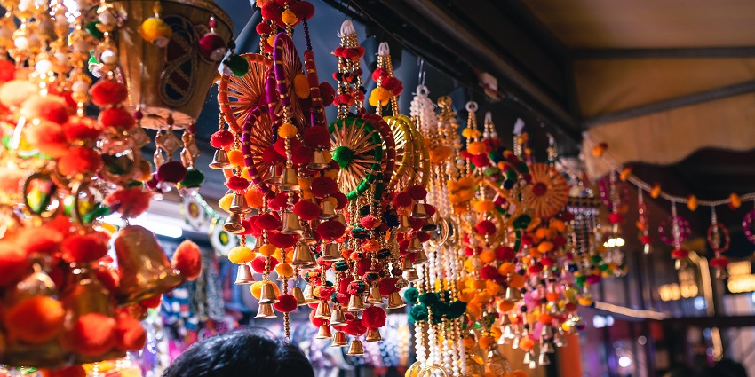 Close up view of traditional Navratri decorations hanging on a shops along the busy roads of Teen Darwaza Market