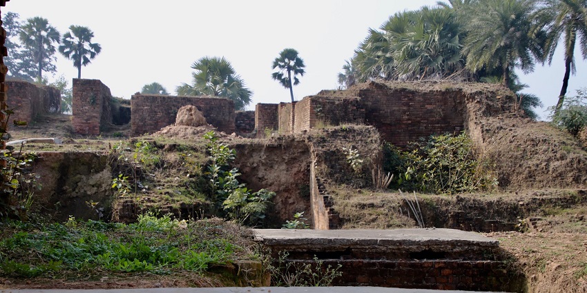 The restored section of this monastery, with partially standing walls and ancient stone steps