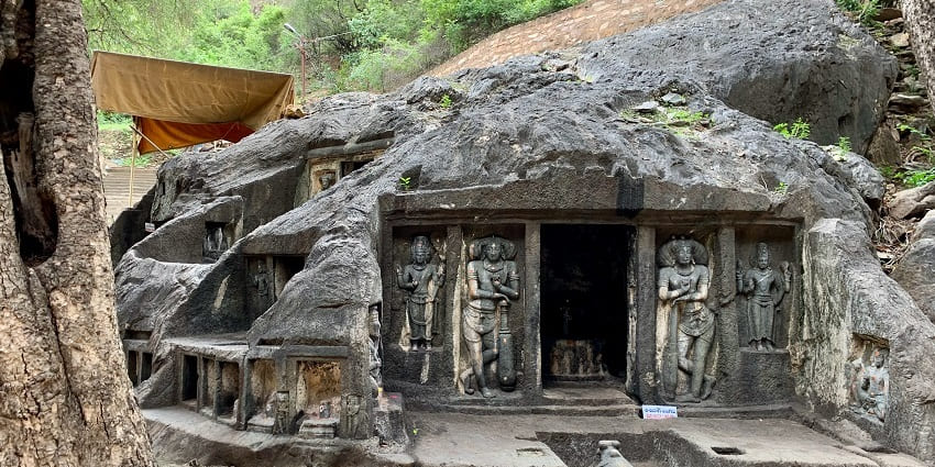 Ancient rock-cut cave temples in Bhairavakona, Andhra Pradesh, showcasing intricate carvings.