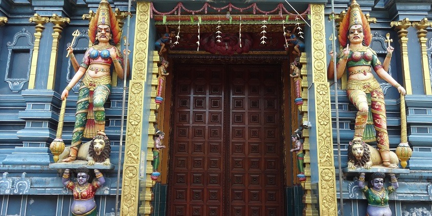 Ornate entry gate of Muthumariamman Temple with intricate designs and vibrant colors