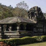 Scenic view of Shri Mahadev Temple in Tambdi Surla, Goa, surrounded by lush greenery