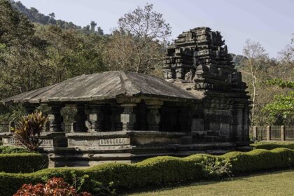 Scenic view of Shri Mahadev Temple in Tambdi Surla, Goa, surrounded by lush greenery