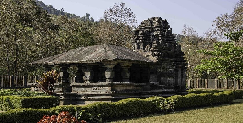 Scenic view of Shri Mahadev Temple in Tambdi Surla, Goa, surrounded by lush greenery