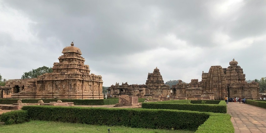 A breathtaking view of a temple surrounded by lush greenery during the daytime for all.