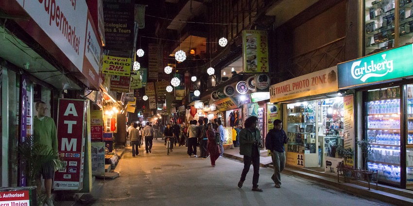 Vibrant Thamel district at night with bustling streets and colourful lights.