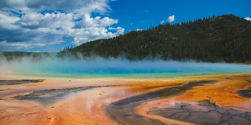A glimpse of the Thap Ba Hot Springs covered in steam and surrounded by forests.