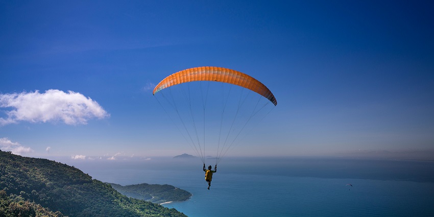 A breathtaking view of a person enjoying an aerial adventure activity during the daytime.
