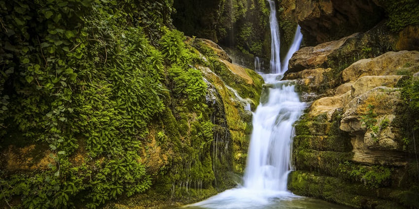 A picture of a beautiful waterfall in Araku Valley, surrounded by lush greenery