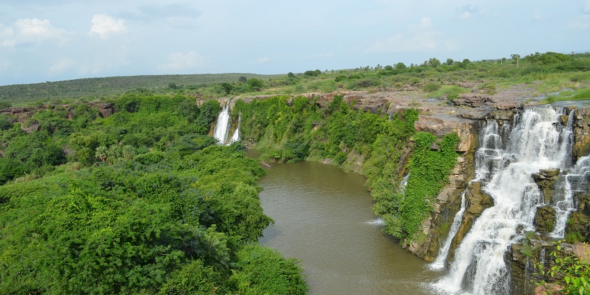 An aerial picture of a waterfall in Visakhapatnam with verdant greenery nearby