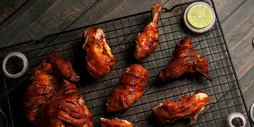 Image of Delicious Grilled Meat on Barbeque Grill Mesh Wire with lemon on the side corners