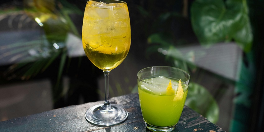 Image of the glasses of cold drinks on wooden table - try delectable cocktails