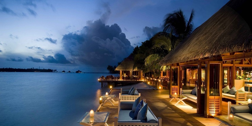 A luxury beachfront hotel featuring modern design elements, expansive glass facades