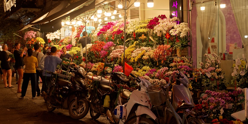 Busy market with vibrant surrounding in the Old Quarter; one of the top places to visit in Hanoi.