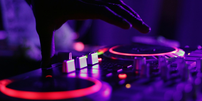 An inside view of The Pier Disco Club featuring a live DJ and acoustical settings.
