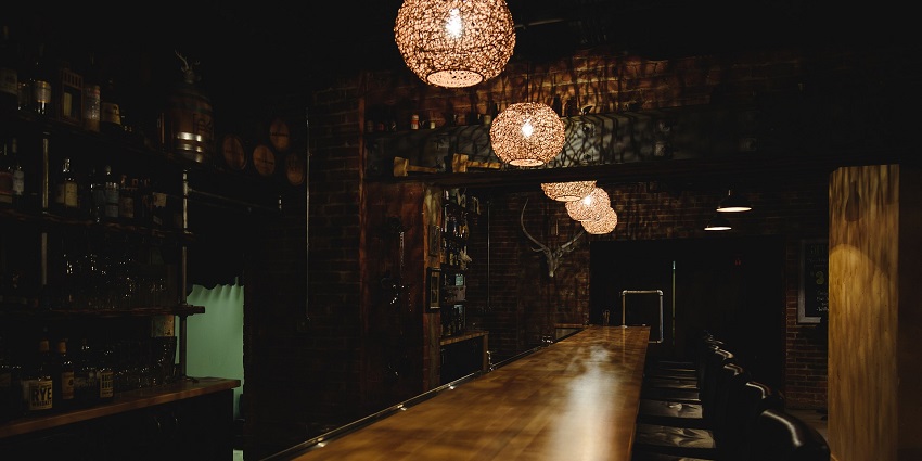 An image of a bar with stools and lights, mirroring a relaxed Bhutan nightlife for singles.