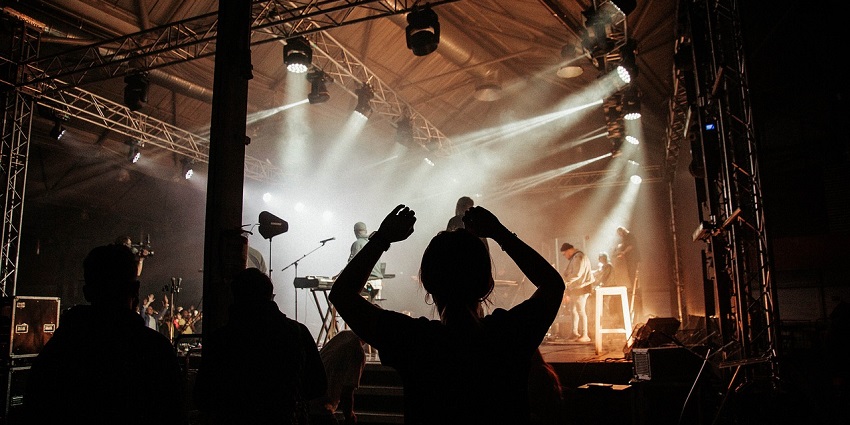 An image of a festival crowd enjoying a lively concert under vibrant lights in Thimphu nightlife.