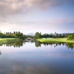 A breathtaking vista of a shimmering lake surrounded by greenery in Maharashtra.