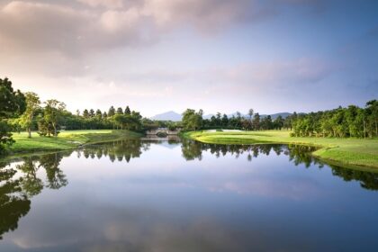 A breathtaking vista of a shimmering lake surrounded by greenery in Maharashtra.