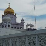 A view of the white beauty of a famous gurudwara adorned with golden hues in Punjab.