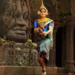 Witness traditional Khmer dancer performing in vibrant attire at a cultural event, a must thing to do in Siem Reap