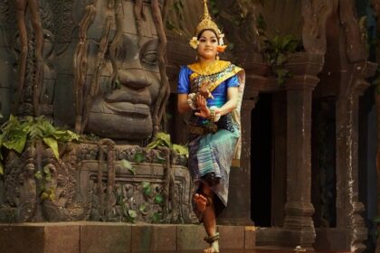 Witness traditional Khmer dancer performing in vibrant attire at a cultural event, a must thing to do in Siem Reap