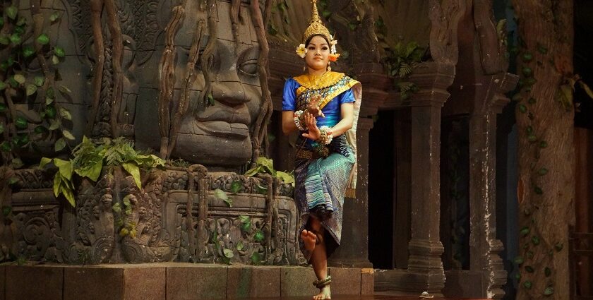 Witness traditional Khmer dancer performing in vibrant attire at a cultural event, a must thing to do in Siem Reap