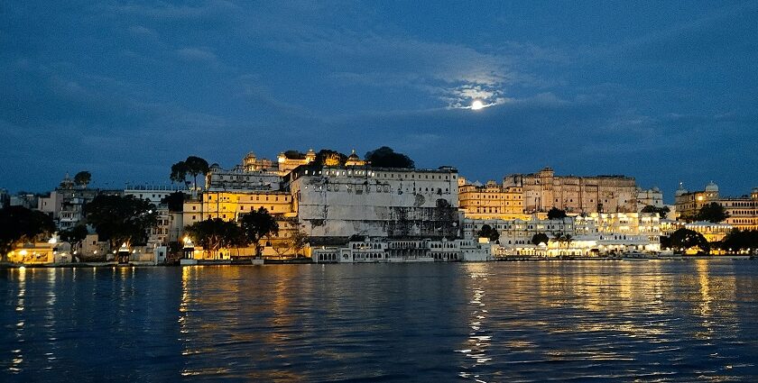 Panoramic view of Udaipur at night, highlighting its lakes and surrounding hills