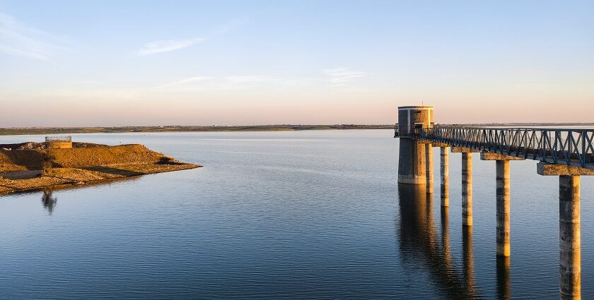 A serene view of shimmering waters featuring a long bridge in Madhya Pradesh.