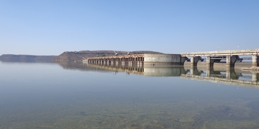 A large concrete dam with spillways is a unique site to explore near Bateshwar temples.