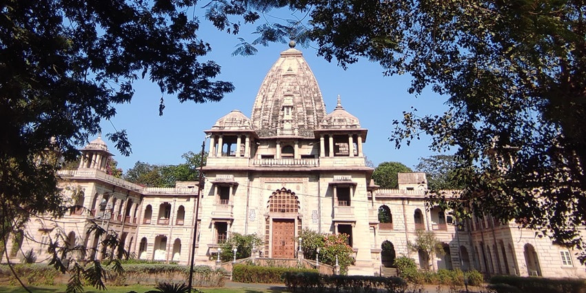 A frontal view of the Tirath Satkumbha Temple with intricate wall carvings and architecture