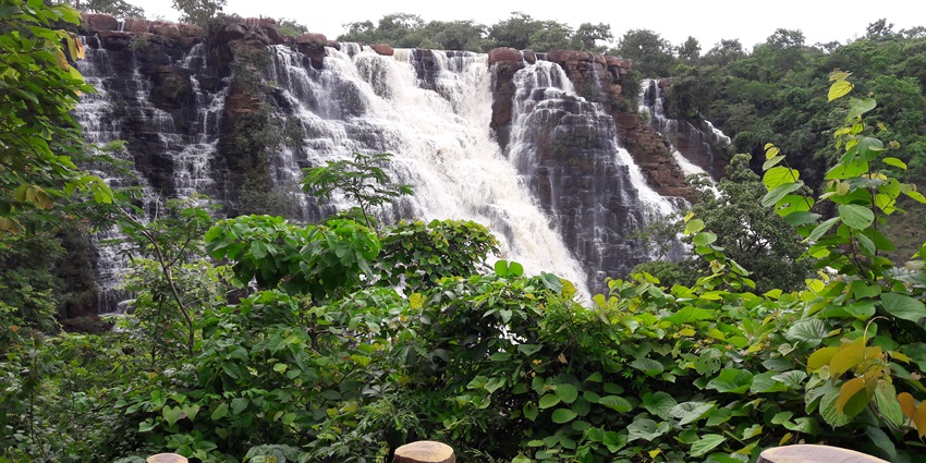From block shaped rocks, a waterfall is falling down and dividing into small waterfalls