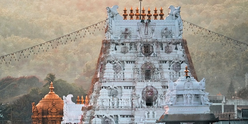 A breathtaking view of the Sri Venkateswara Swamy Temple around greenery during the day.