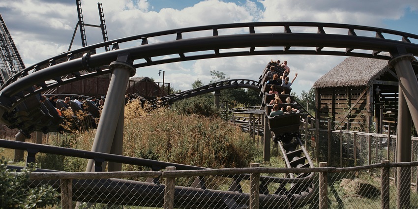 Image of a roller coaster people enjoying the rides in an adventure park