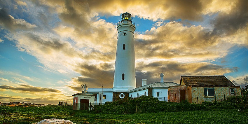 The towering lighthouse of the Tomb of St. Francis Xavier surrounded by greenery.