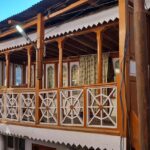 An exterior view of a Gurudwara in Kargil that features wooden architecture.