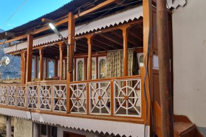 An exterior view of a Gurudwara in Kargil that features wooden architecture.