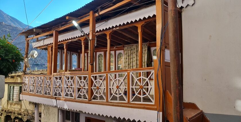 An exterior view of a Gurudwara in Kargil that features wooden architecture.