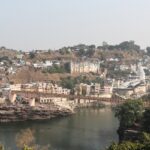 A scenic view of Omkareshwar from the Narmada River which is a top tourist attraction