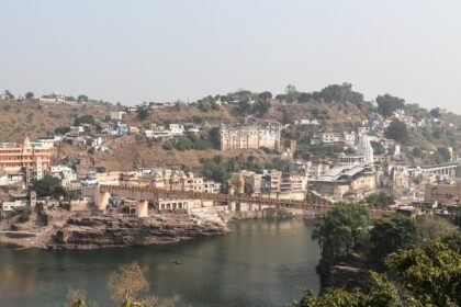 A scenic view of Omkareshwar from the Narmada River which is a top tourist attraction