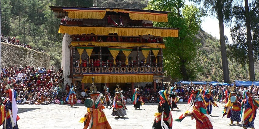 Traditional festival dance with masks and drums, showcasing Bhutanese culture.