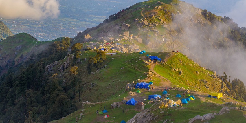 Stunning view of the Triund Trek path winding through the mountains, with scenic valleys below