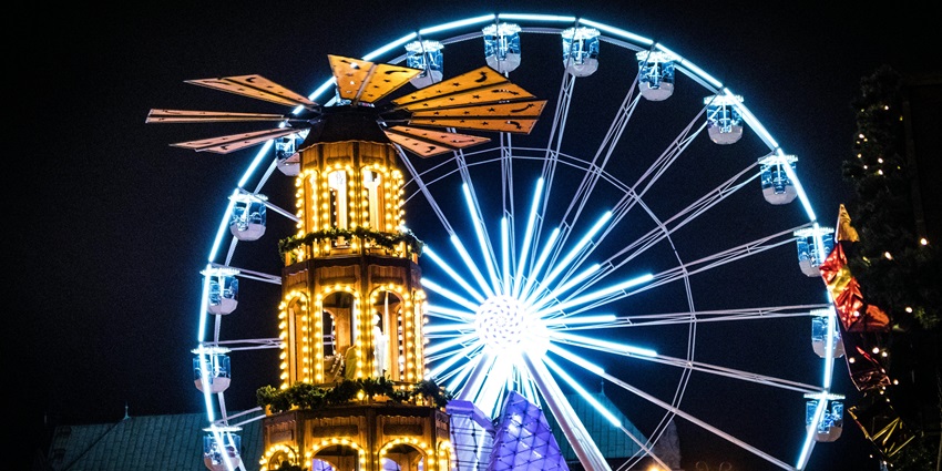 Scenic view of the Asiatique Ferris Wheel Ride adorned with golden and blue lights at night.