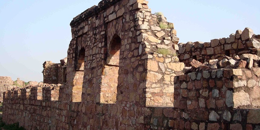 Tughlaqabad Fort's impressive stone architecture and arched gateways
